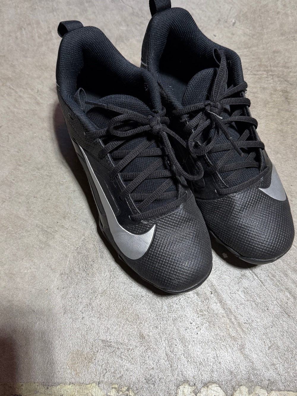 Nike kids Black Athletic cleats with Silver Swoosh